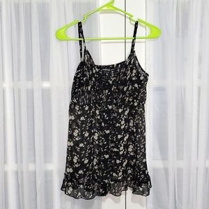 Sheer floral adjustable spaghetti strap baby doll top.